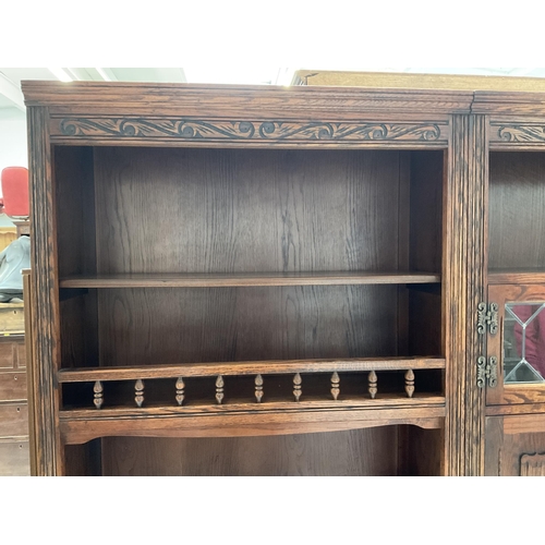 416 - BADGED OLD CHARM LOUNGE UNIT TOP WITH OPEN SHELVES 2 GLASS LEADED DOORS WITH DROP DOWN BUREAU WITH L... 