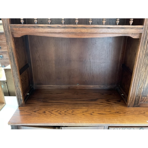 416 - BADGED OLD CHARM LOUNGE UNIT TOP WITH OPEN SHELVES 2 GLASS LEADED DOORS WITH DROP DOWN BUREAU WITH L... 