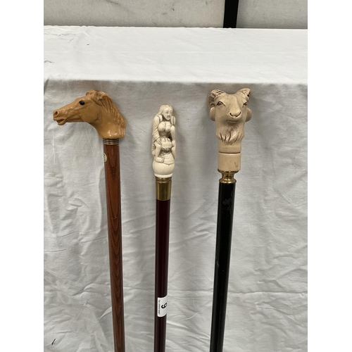 9 - 3 WALKING CANES WITH DECORATIVE CARVED HANDLES (RAMS HEAD, EROTIC, HORSES HEAD) - H 37