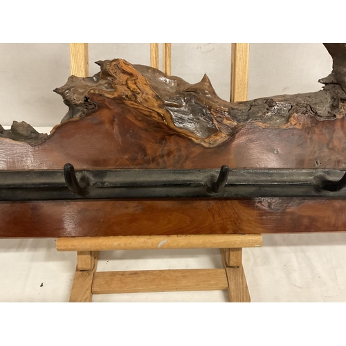 195 - YEW WOOD COAT RACK WITH CAST IRON HOOKS FLANKED BY CAST IRON BULLS HEADS L41.5