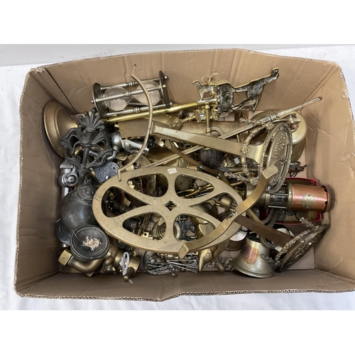 202 - BOX OF BRASSWARE TO INCLUDE BRASS TAPS TRIVETS BELLS FIRE DOGS AND EARLY CAST METAL LAMP