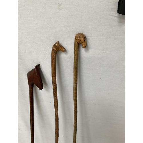 424 - QTY OF WALKING CANES WITH CARVED ANIMAL HEADS - LONGEST 59