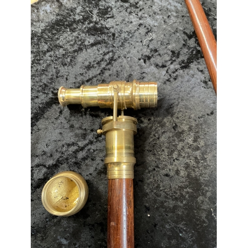 428 - 2 MODERN WALKING CANES 1 FITTED WITH A BRASS TELESCOPE AND 1 WITH A COMPASS - LONGEST 36