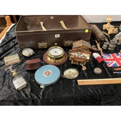 92 - VINTAGE SUITCASE AND CONTENTS TO INCLUDE VINTAGE BINOCULARS, METAL ELEPHANT MONEY BOX, BAROMETER, TA... 