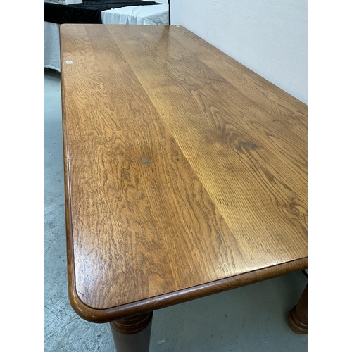 338 - LARGE HEAVY OAK DINING TABLE ON 4 TURNED LEGS WITH 8 MATCHING RAILBACK CHAIRS WITH UPHOLSTERED SEATS... 