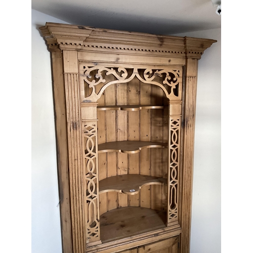 58 - LARGE WAXED PINE CORNER CABINET WITH CARVED OPEN TOP WITH 2 DOORS TO BASE H84