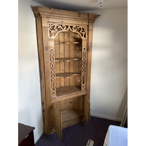 58 - LARGE WAXED PINE CORNER CABINET WITH CARVED OPEN TOP WITH 2 DOORS TO BASE H84