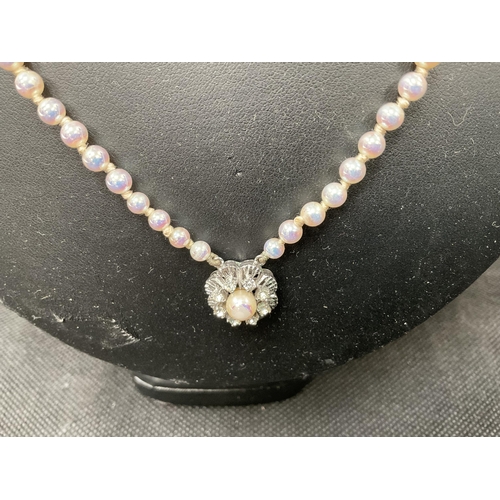 127 - DOUBLE STRAND OF PEARLS WITH FANCY WHITE METAL CLASP