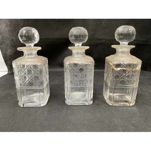 134 - ANTIQUE OAK TANTALUS WITH 3 CUT GLASS BOTTLES (1 A/F) WITH PLATED FITTINGS AND KEY H11