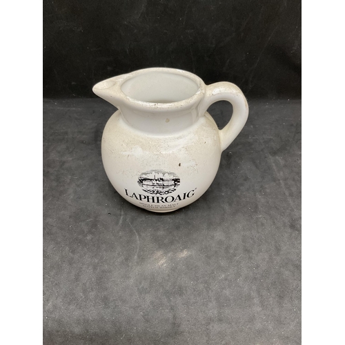 144 - 3 PIECES OF MILLBRO CAFE CRAVEN ARMS ADVERTISING CHINA ALONG WITH A LAPHROAIG WHISKY WATER JUG