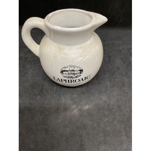 144 - 3 PIECES OF MILLBRO CAFE CRAVEN ARMS ADVERTISING CHINA ALONG WITH A LAPHROAIG WHISKY WATER JUG