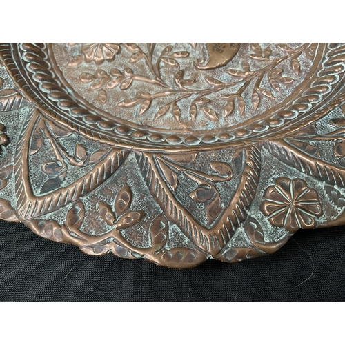 192 - ANTIQUE COPPER DISH WITH HAND RAISED DECORATION OF STYLISED FLOWERS DIA 10