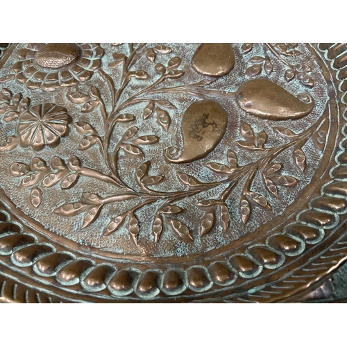 192 - ANTIQUE COPPER DISH WITH HAND RAISED DECORATION OF STYLISED FLOWERS DIA 10