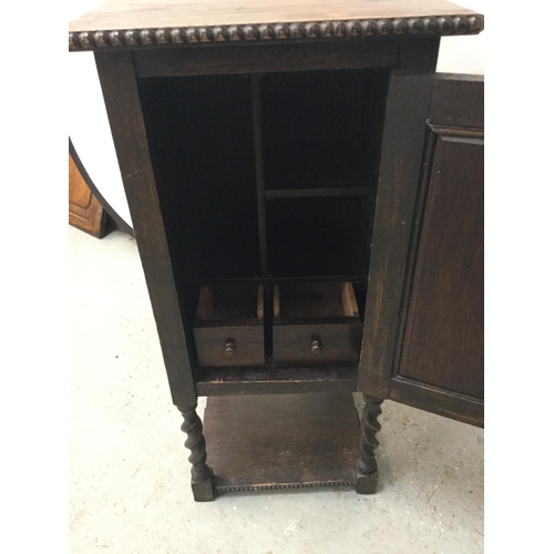 263 - VINTAGE OAK BEDSIDE CABINET WITH FITTED INTERIOR ON BARLEY TWIST LEGS WITH CARVED INITIALS TO THE DO... 