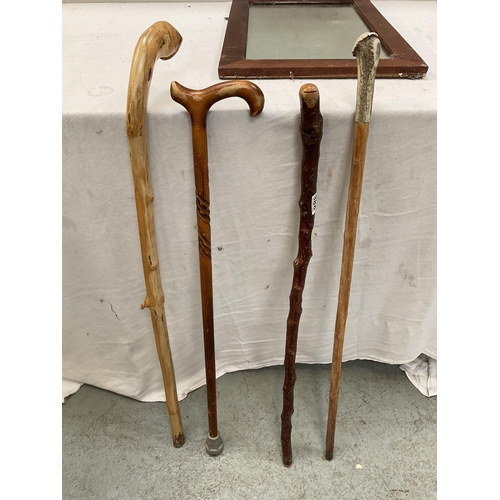 388 - 4 WALKING STICKS AND A WOOD FRAMED WALL MIRROR