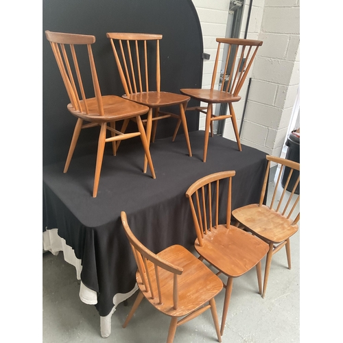 243 - 6 BLONDE ERCOL STRETCHERED DINING CHAIRS WITH SPINDLE BACK (1 NEEDS REPAIR)