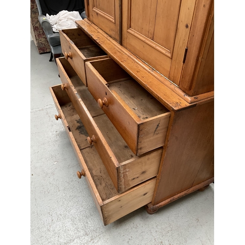 299 - VICTORIAN PINE PRESS WITH TWO DOORS TO TOP WITH FITTED SHELVES TO INTERIOR WITH 2 SHORT DRAWERS OVER... 