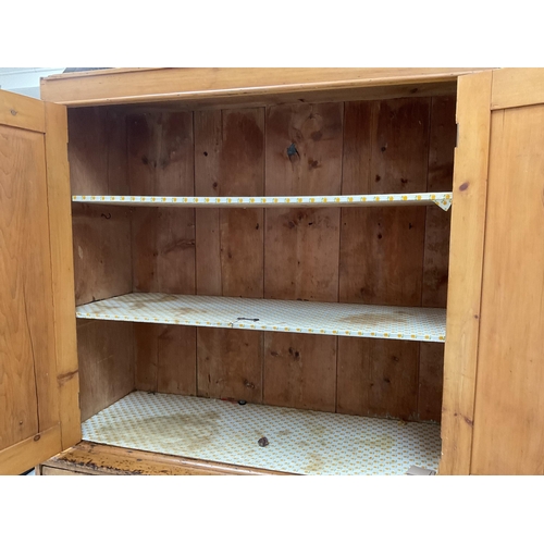 299 - VICTORIAN PINE PRESS WITH TWO DOORS TO TOP WITH FITTED SHELVES TO INTERIOR WITH 2 SHORT DRAWERS OVER... 