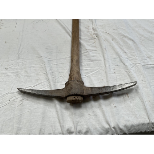 39 - 2 VINTAGE HAY FORKS AND A VINTAGE PICK AXE