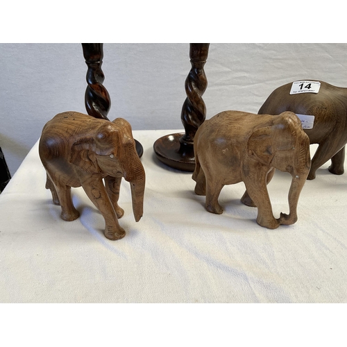 14 - 3 CARVED ELEPHANTS AND A PAIR OF BARLEY TWIST CANDLESTICKS