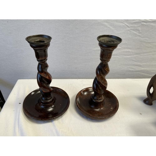 14 - 3 CARVED ELEPHANTS AND A PAIR OF BARLEY TWIST CANDLESTICKS