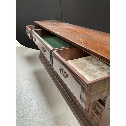 281 - LARGE OAK REPRODUCTION SIDEBOARD WITH 3 DRAWERS TO TOP AND 4 DOORS BELOW BADGED YOUNGER H30