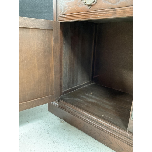 281 - LARGE OAK REPRODUCTION SIDEBOARD WITH 3 DRAWERS TO TOP AND 4 DOORS BELOW BADGED YOUNGER H30