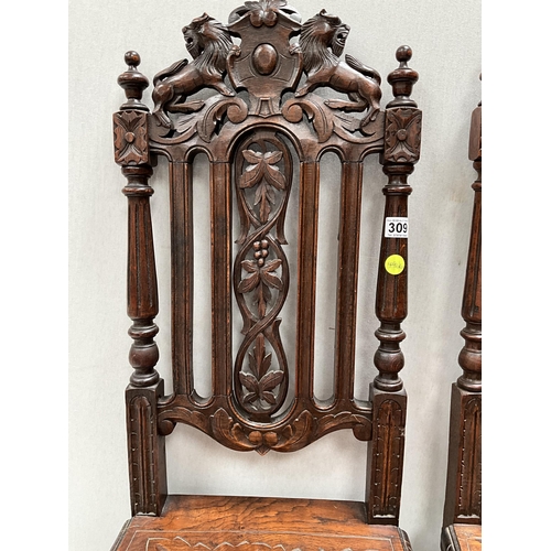 309 - PAIR OF HEAVILY CARVED OAK HALL CHAIRS WITH LION DECORATION TO TOP, CARVED SEATS AND STRETCHERED BAS... 