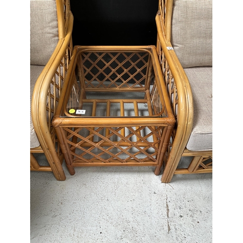 312 - PAIR OF CANE CONSERVATORY CHAIRS AND MATCHING GLASS TOPPED COFFEE TABLE