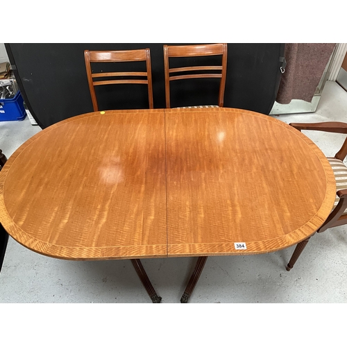 384 - REPRODUCTION REGENCY STYLE MAHOGANY TWIN PEDESTAL DINING TABLE WITH EXTRA LEAF AND 6 MATCHING CHAIRS... 