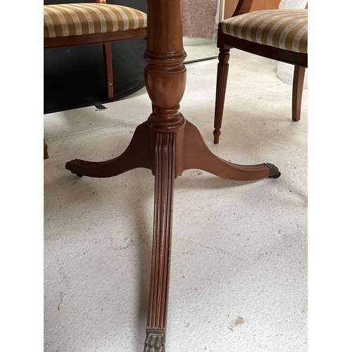 384 - REPRODUCTION REGENCY STYLE MAHOGANY TWIN PEDESTAL DINING TABLE WITH EXTRA LEAF AND 6 MATCHING CHAIRS... 