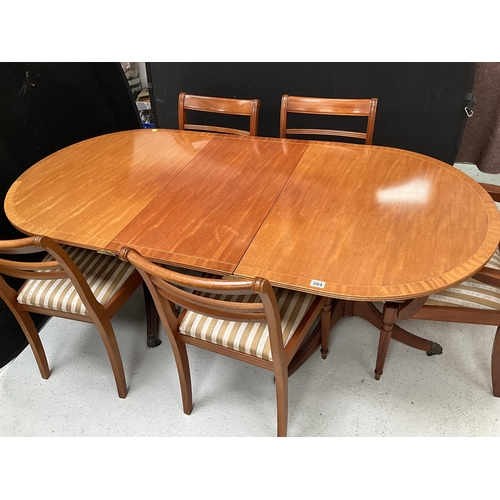 384 - REPRODUCTION REGENCY STYLE MAHOGANY TWIN PEDESTAL DINING TABLE WITH EXTRA LEAF AND 6 MATCHING CHAIRS... 