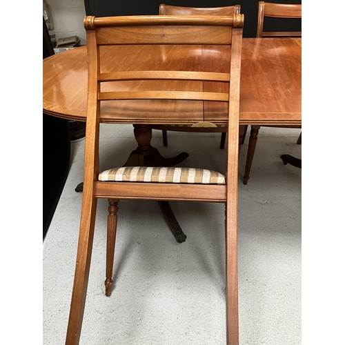 384 - REPRODUCTION REGENCY STYLE MAHOGANY TWIN PEDESTAL DINING TABLE WITH EXTRA LEAF AND 6 MATCHING CHAIRS... 