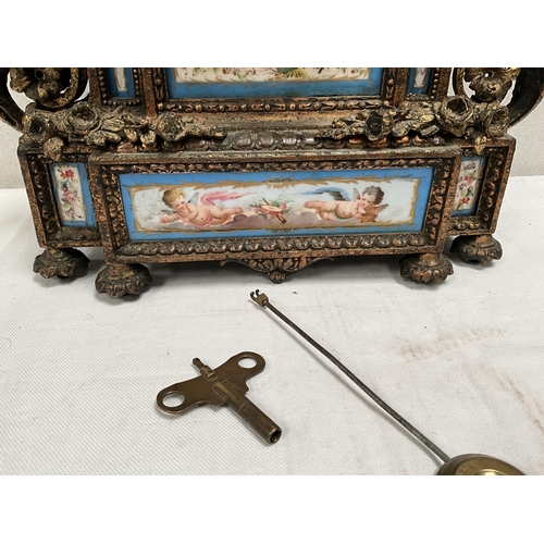 204 - FRENCH GILT METAL MANTEL CLOCK WITH PORCELAIN FACE AND PANELS DECORATED WITH BIRDS FOILAGE CHERUBS E... 