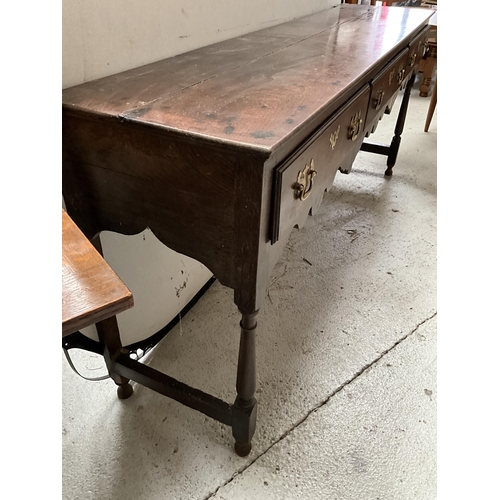 402A - EARLY OAK 3 DRAWER DRESSER BASE ON TURNED AND STRETCHERED LEGS WITH SHAPED FREEZE H32