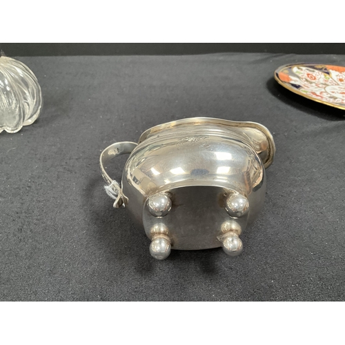 205 - HALLMARK SILVER CREAM JUG, 2 NAPKIN RINGS, COLLARED SCENT BOTTLE 
APPROX TOTAL WEIGHT 155G