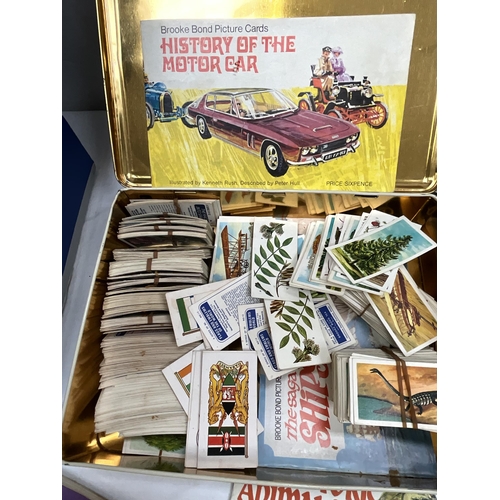 53 - BOX OF BOOKS TO INCLUDE TEA CARDS, FOSSILS, 2 AA MEMBERS ANNUAL BOOKS, MOTORCYLE PROGRAMMES TT ETC