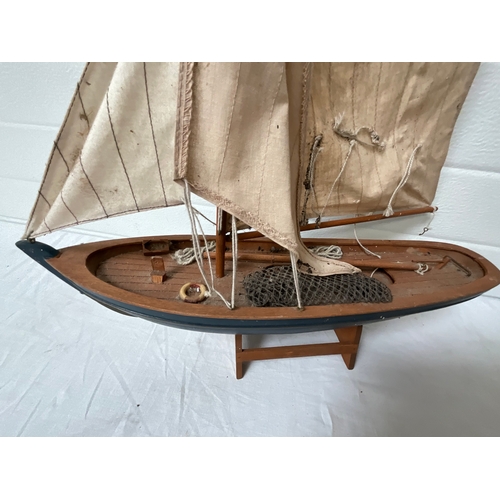 329 - BOX OF WOODEN ITEMS, ENAMEL PAN AND WOODEN BOAT