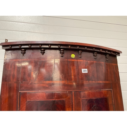 389 - GEORGIAN MAHOGANY INLAID BOW FRONTED HANGING CORNER CABINET WIHT DRAWER TO BASE FITTED WITH SHELVES ... 