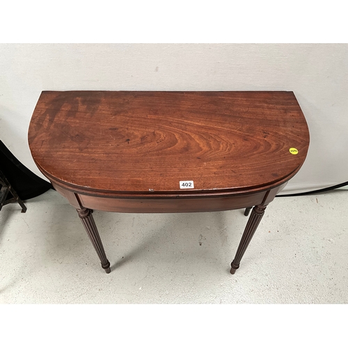 402 - GEORGE III MAHOGANY FOLDING TOPPED TEA TABLE ON REEDED LEGS H28