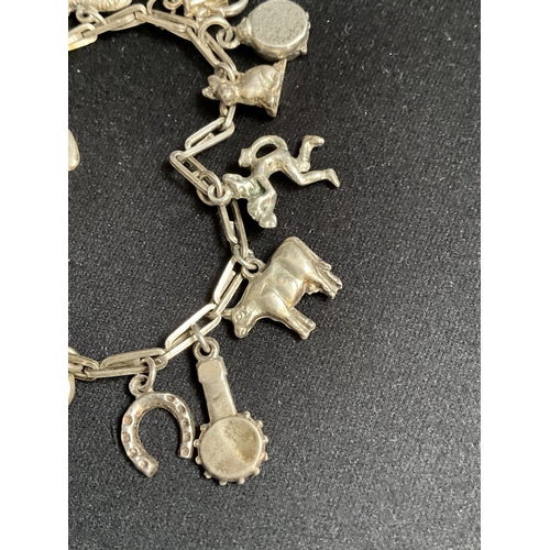 228 - SILVER CHARM BRACELET WITH 14 SILVER CHARMS - TOTAL WEIGHT 27G