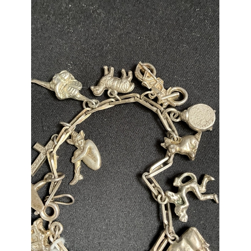 228 - SILVER CHARM BRACELET WITH 14 SILVER CHARMS - TOTAL WEIGHT 27G