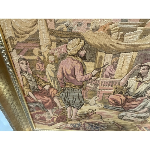 369 - LARGE GILT FRAMED TAPESTRY PICTURE - STREET SCENE 22