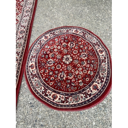 390 - 2 X RED PATTERNED CARPETS 
DIA 31.5