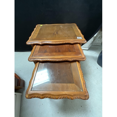 407 - REPRODUCTION YEWWOOD NEST OF 3 TABLES WITH GLASS TOPS H21.5