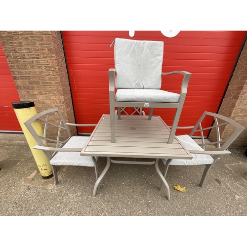 428 - METAL GARDEN TABLE AND 4 MATCHING CHAIRS COMPLETE WITH CUSHIONS H28