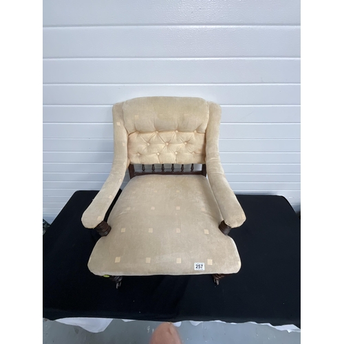 257 - GOLD UPHOLSTERED BEDROOM ARMCHAIR ON ORIGINAL BRASS CASTORS