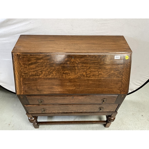 352 - VINTAGE OAK BUREAU WITH FITTED INTERIOR AND 2 DRAWERS OVER STRETCHERED BASE H39