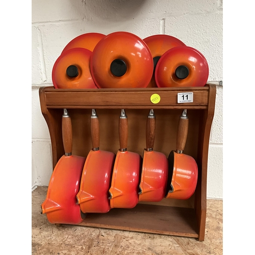 11 - FRENCH CAST IRON LE CREUSET PAN SET COMPLETE WITH LIDS, STAND AND FRYING PAN