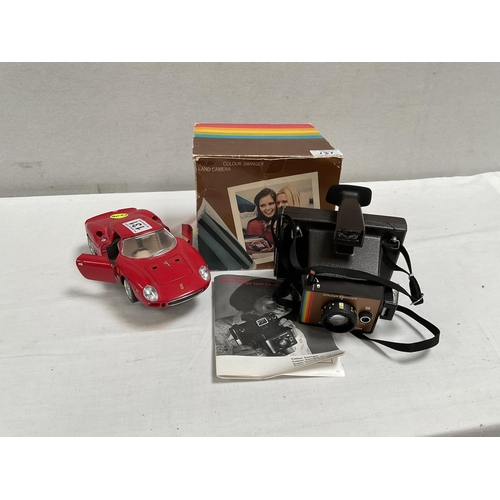 131 - VINTAGE POLAROID CAMERA AND MODEL FERRARI CAR